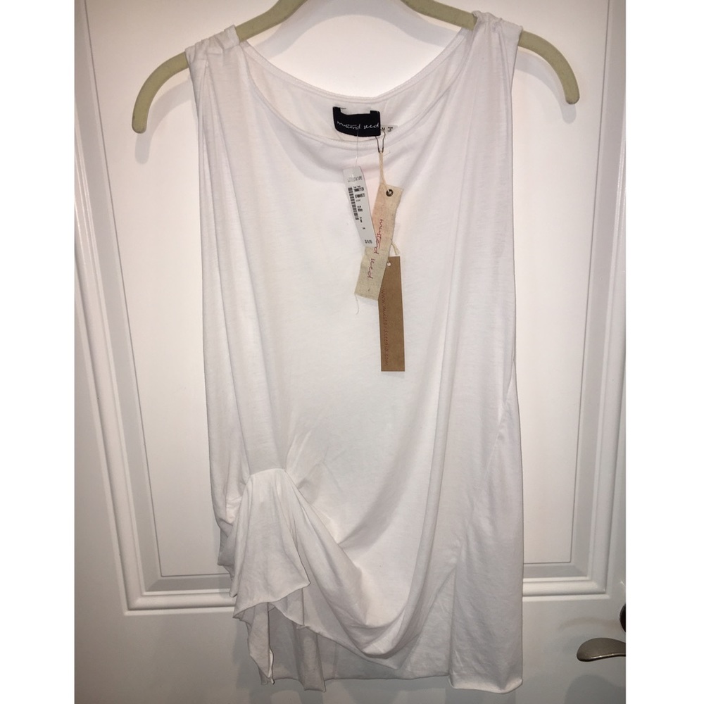 New white sleeveless blouse with cinched waist